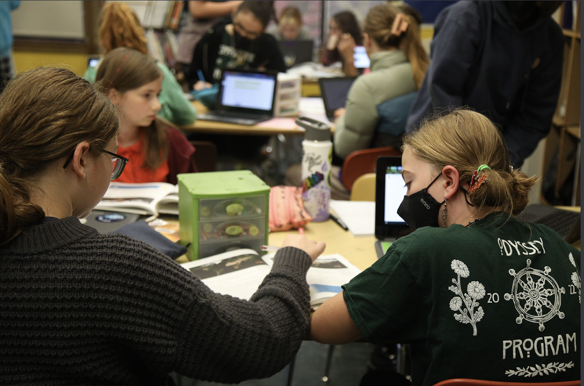 Students at a desk working.