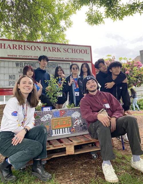 kids in front of school sign