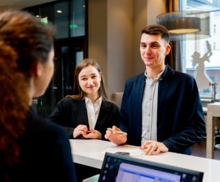 Students at a hotel reception desk
