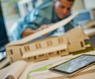 Students examines a model of a building