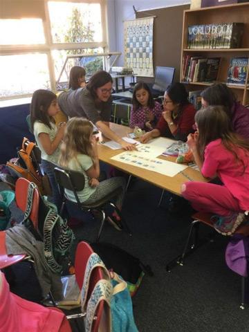 Students and teacher at a table 