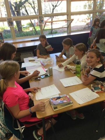 Students and teacher at a table 
