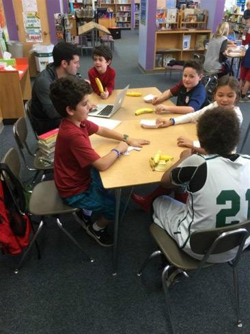 Students and teacher at a table 