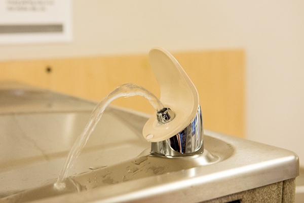  Water fountain with flowing stream of water.