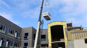 HVAC unit lifted to roof 