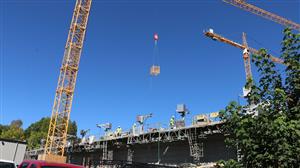 photos show the "mules" which are equipment being used by the masons to maintain safe social distancing between workers and t 