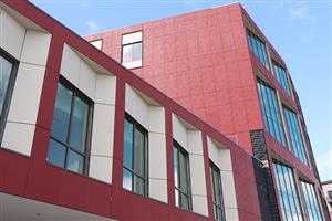 6 story tower of the new Lincoln with red paneling and ample windows