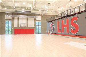 Smaller gym with logo on back of the bleacher seats