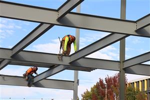 workers putting steel beams in place