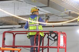 Construction working installing electrical