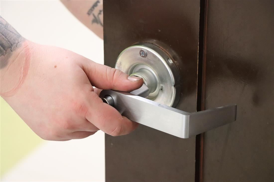 Student reaching for door handle