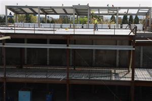 worker walking on competed roofing