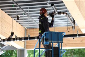Worker adding piping in the ceiling