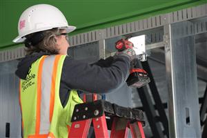 Female construction working installing metal plate