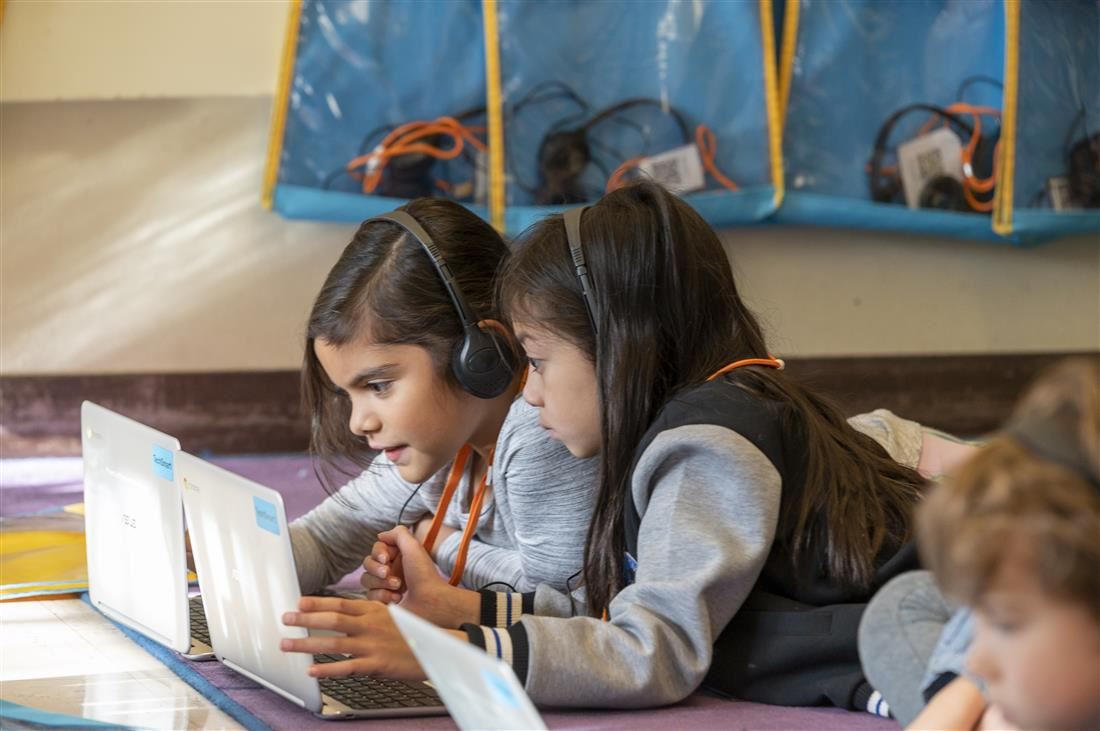 students reading on laptops