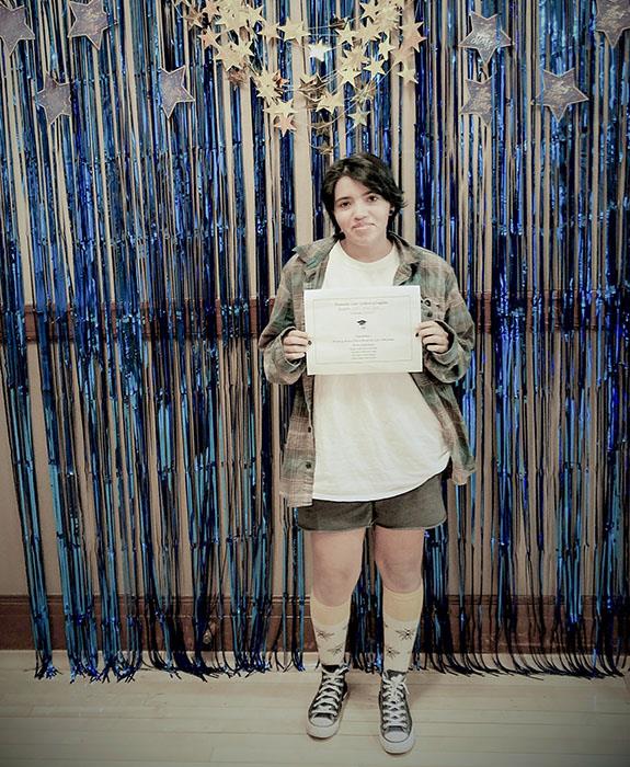 Graduate posing with diploma