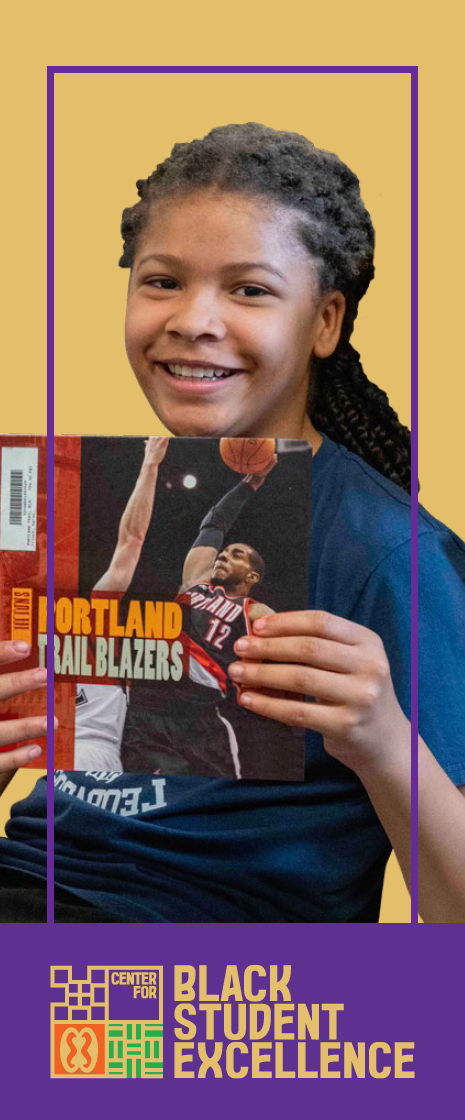 Smiling student reading a book