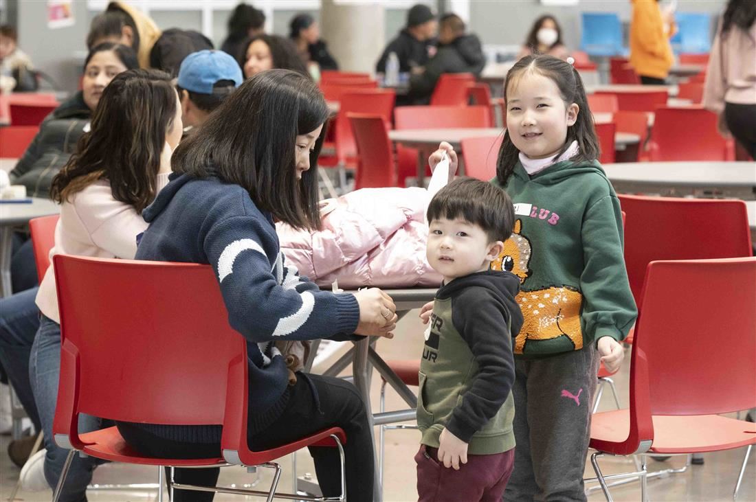 Kids sitting at table with parent