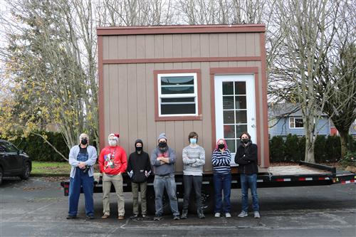Tinyhouse with students posing for photo